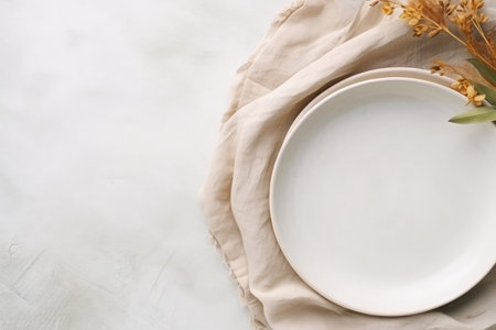 Top down view of white plate utensils and napkin on white stone table Empty space for duplicationの素材