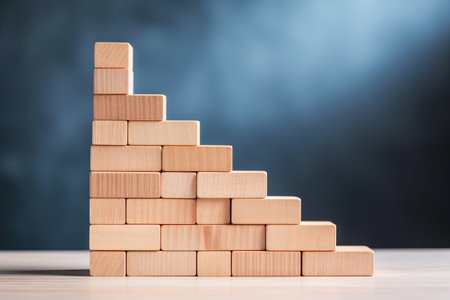 Career ladder for success in business growth depicted with wooden blocks stacked as stairs showing aの素材