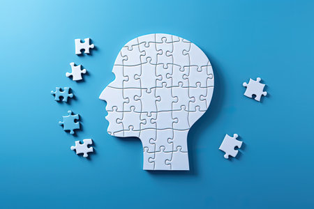 Mental health and memory issues illustrated with brain jigsaw on blueの素材