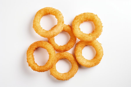 Top view of onion rings on a white backgroundの素材