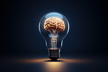 Human brain contained in a light bulb on a dark backdropの素材