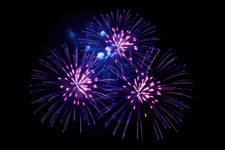 Fireworks in Mqabba during a festival exploding in blue and purple colors against a dark backgroundの素材