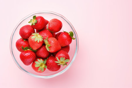 Delicious juicy strawberries on pink table Copy space availableの素材