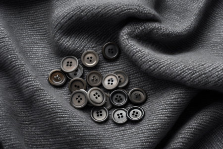 Gray knitted fabric with metal buttonsの素材