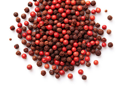 Black peppercorns in a heap on white background from aboveの素材