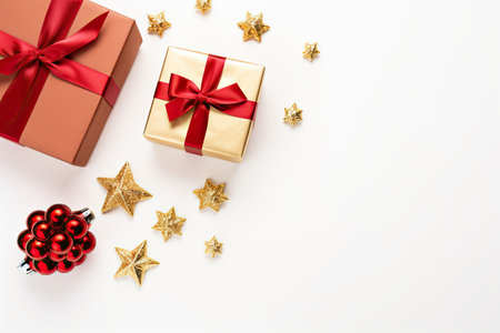 Christmas items - gifts, red and gold decorations on white backdrop. Overhead view, arranged flat.の素材