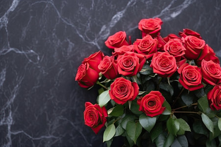 Outdoor funeral ceremony with space for text on black granite tombstone adorned with red rosesの素材