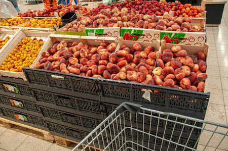 Russia, Supermarket- July 3 2019-Shopping for fruits and vegetables in a supermarket with a shopping cartのeditorial素材