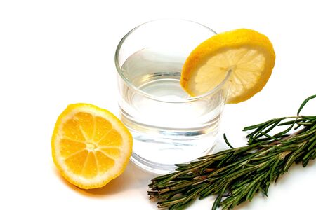 Glass of pure water with lemon isolated on a white backgroundの写真素材