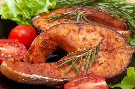 Grilled Salmon Steaks on a Plate with Lemon and Tomatoの写真素材