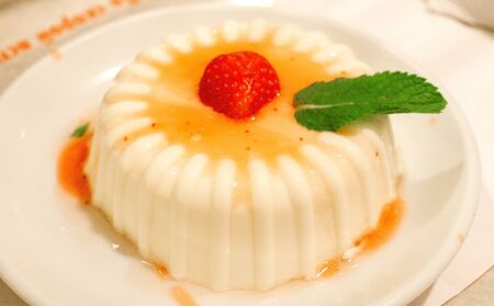Italian panakota dessert on a plate with strawberriesの写真素材