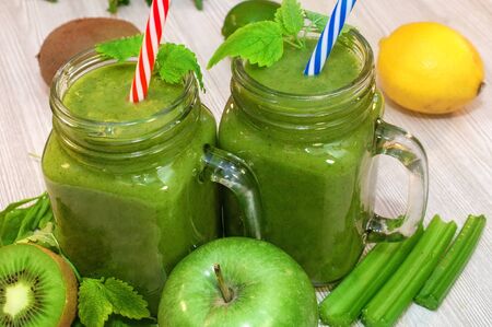 Kiwi, banana, apple and fresh greens smoothie for detox cleansingの写真素材
