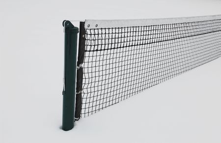 Tennis court half buried in snow in winterの写真素材