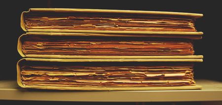 Three vintage books lying on library book shelfの写真素材