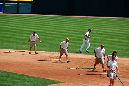 DETROIT, MI - JULY 11: Groundskeepers at work during the Detroit Tigers game against the Minnesota...