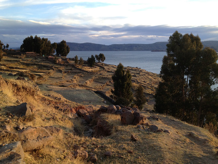 AMANTANI, PUNO, PERU - AUGUST 6:  Sun setting over the terraces in Amantani in Lake Titicaca, Peru on August 6, 2013. Families have farmed in Amantani since before the time of the Incas. のeditorial素材