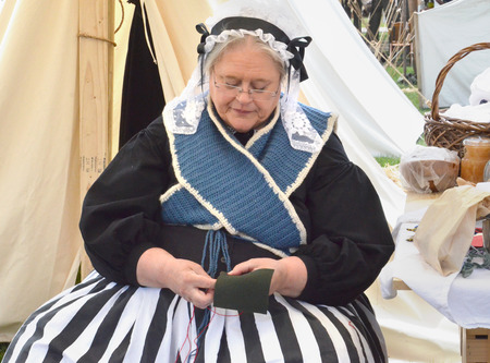 DEARBORN, MI - MAY 26: Civil-war era re-enactor sewing during the Civil War remembrance at...