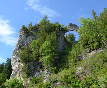 MACKINAC ISLAND, MI, USA- JUNE 21: Arch Rock in Mackinac Island, MI, shown here on June 21, 2014, is fifty feet wide and was formed by erosion of the soft rock underneath the breccia rock that remains.のeditorial素材