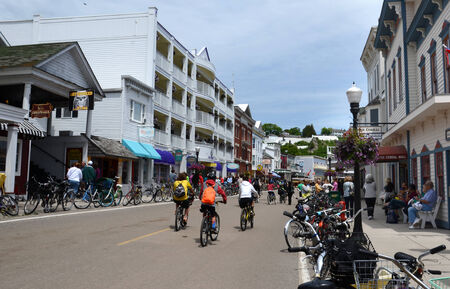 MACKINAC ISLAND, MI, USA- JUNE 21: Bicyclist ride in downtown Mackinac Island, MI on June 21, 2014. No powered automobiles are allowed on the island. のeditorial素材