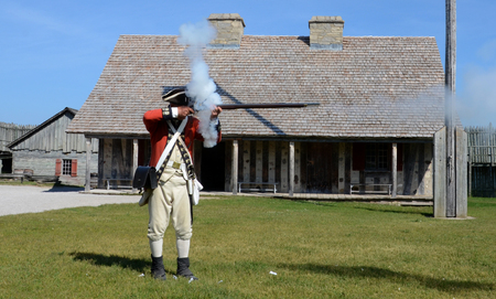 MACKINAW CITY, MI, USA- JUNE 22: A re-enactor demonstrates how to fire a musket at Fort Michilimackinac in Mackinaw City, MI on June 22, 2014. のeditorial素材