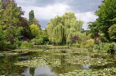 GIVERNY, FRANCE - AUG 5:  A weeping willow can be seen across the pond in the garden of Claude Monet in Giverny, France, on August 5, 2016.のeditorial素材