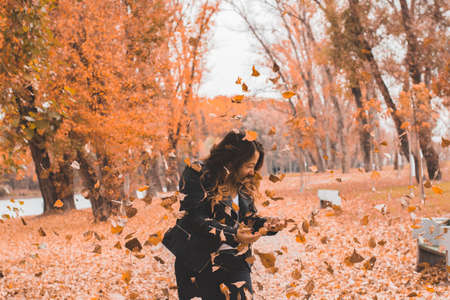 Beautiful Girl Among Falling Leaves - Autumn portraitの写真素材