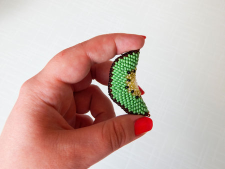 Colorful bright key chain in hand. Hand holding a colorful keychainの写真素材