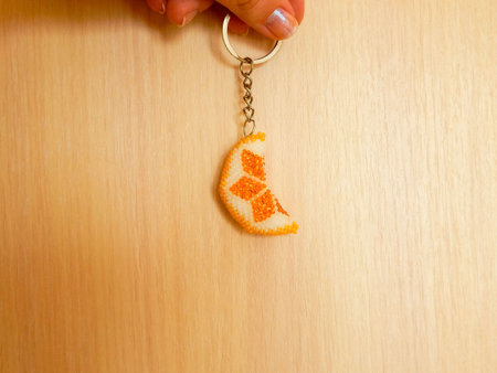 Colorful key chain on a beige. Bead colorful key chain on a beige