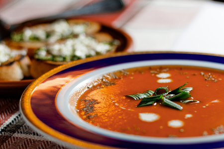 Tomato soup in a plate on a table. Selective focusの写真素材