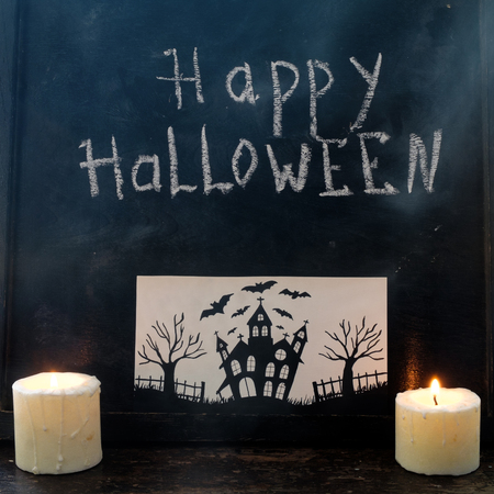 Halloween pumpkin on a black wooden background with a cardの写真素材