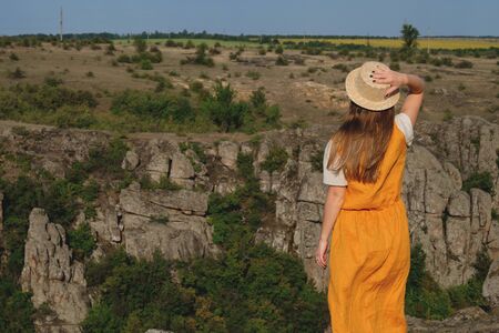 happy young girl standing on a background of the canyonの写真素材