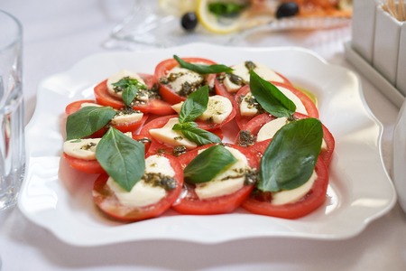 Salad caprese made of tomato, mozzarella and basil