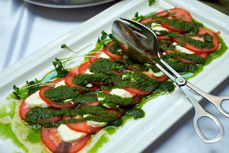 Salad caprese made of tomato, mozzarella and basilの写真素材