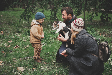 Parents give the child a dog fox terrier. Outdoorの写真素材