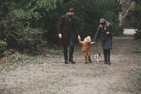 Happy family playing with dog fox terrier. Outdoorの写真素材