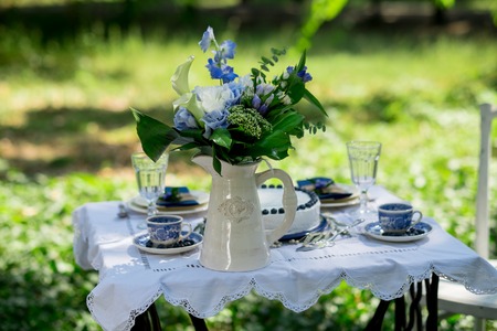 Cake with blue cream for men, decorated with blackberry and blueberry. Hands of Chef decorate the cake with berries. Selective focus.の写真素材
