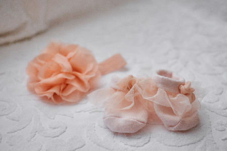Pink baby booties on white background with copy spaceの写真素材
