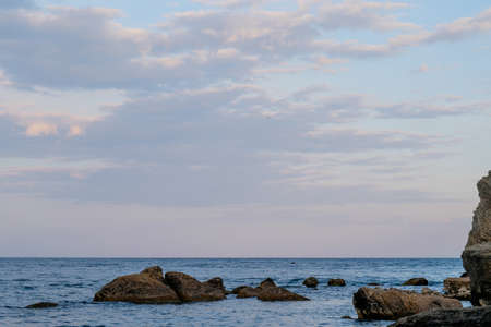 blue sea and clouds in sky over itの写真素材