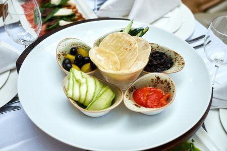Olives tomatoes zucchini crisps. Vegetarian snack. Healthy foodの写真素材
