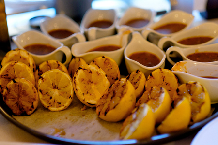 Lemon on a grill pan. Toned. Grilled lemons with sauce