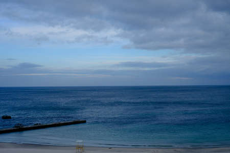 blue sea and clouds in sky over itの写真素材
