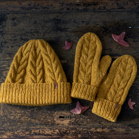 yellow knitted tweed hat with a pattern on a gray backgroundの写真素材