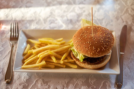 burger and french fries on the wooden tableの写真素材