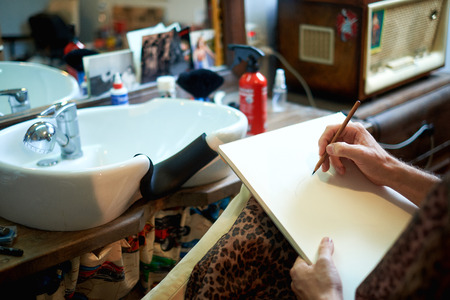 barbershop close-up of an artist's hand paint