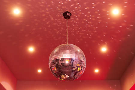 Red disco mirror ball in the club partyの写真素材