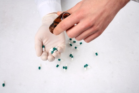 close up of hands and medicine pillsの写真素材