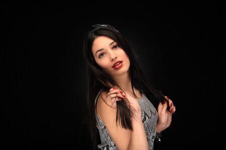 portrait of beautiful young girl on black backgroundの写真素材