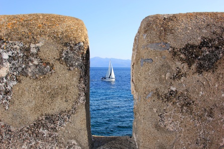 small sailing boat in the waters of a greek island