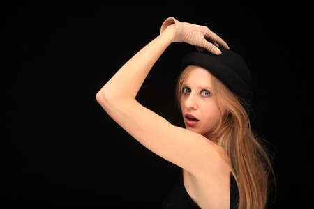 portrait of a pretty young girl making expression on black background