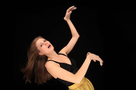 pretty blond girl making expression on a black backgroundの写真素材